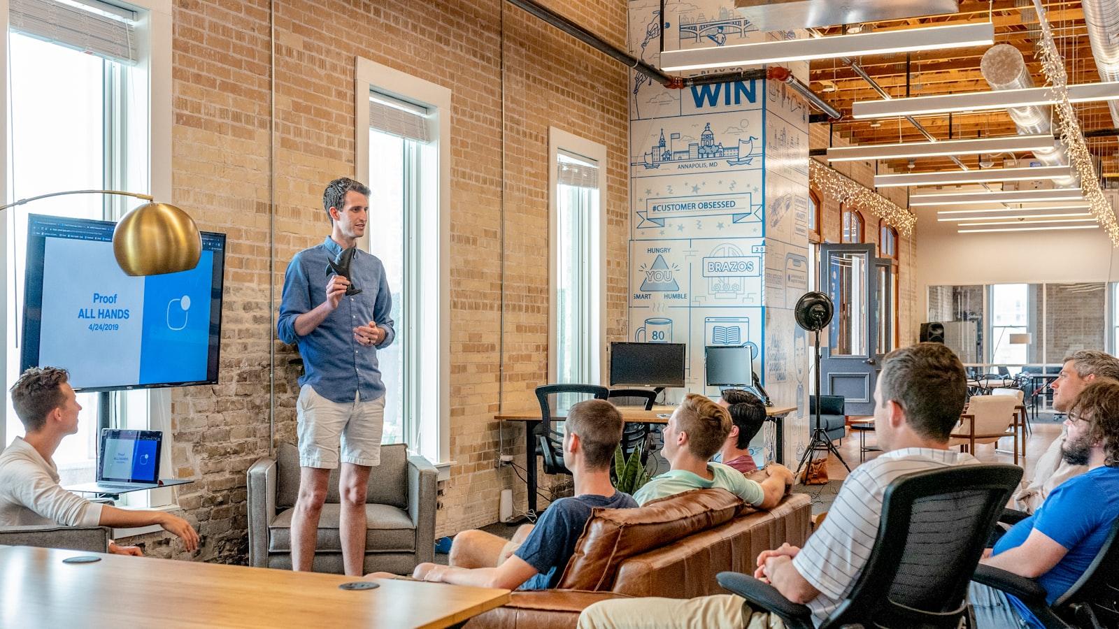 An engineer presenting to colleagues in a small office